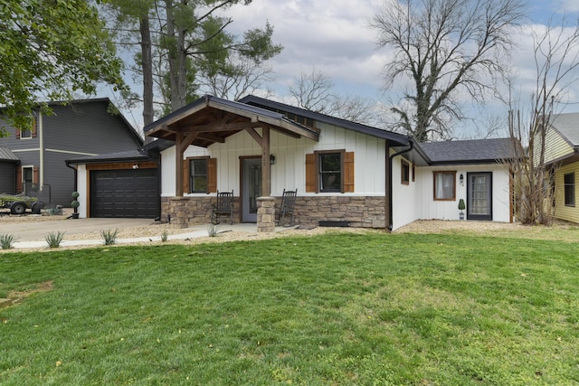 1428 Acacia Club Rd, Hollister, MO 65672 - view of front of home with driveway, board and batten siding, stone siding, a front yard, and a garage