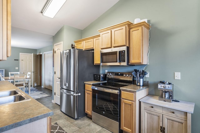 32 Homewood Ln, Kimberling City, MO 65686 - kitchen with light brown cabinetry, appliances with stainless steel finishes, vaulted ceiling, and light countertops