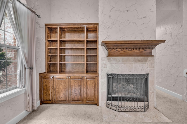 3607 Quail Run Rd, West Plains, MO 65775 - unfurnished living room featuring a tiled fireplace, baseboards, and carpet floors