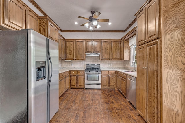 3607 Quail Run Rd, West Plains, MO 65775 - kitchen with appliances with stainless steel finishes, a sink, brown cabinetry, under cabinet range hood, and dark wood-type flooring
