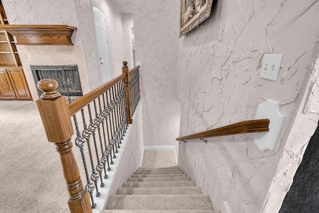 3607 Quail Run Rd, West Plains, MO 65775 - stairway featuring carpet flooring, a tiled fireplace, and a textured wall