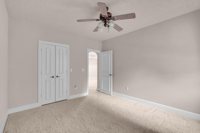 3607 Quail Run Rd, West Plains, MO 65775 - unfurnished bedroom with carpet flooring, baseboards, a closet, ceiling fan, and a textured ceiling
