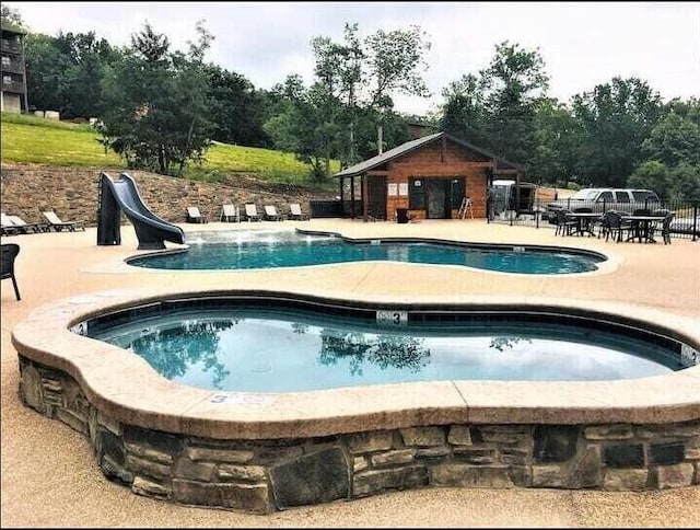 164 Dogwood Park Trl Bldg 1204, Branson, MO 65616 - pool featuring a community hot tub, an outbuilding, a patio, and a water slide