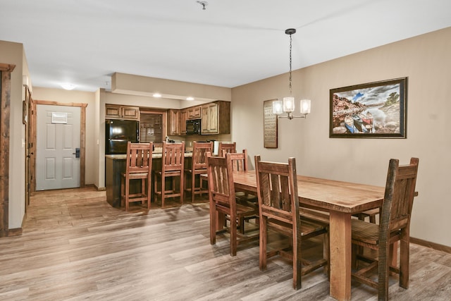 164 Dogwood Park Trl Bldg 1204, Branson, MO 65616 - dining space with baseboards, light wood-type flooring, and an inviting chandelier