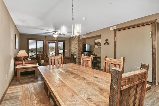 164 Dogwood Park Trl Bldg 1204, Branson, MO 65616 - dining room with ceiling fan with notable chandelier, baseboards, and light wood-type flooring