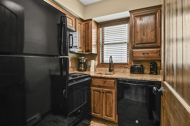 164 Dogwood Park Trl Bldg 1204, Branson, MO 65616 - kitchen featuring brown cabinets, black appliances, light stone countertops, and a sink