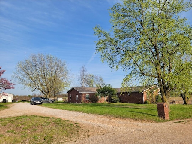 7 Lawrence Unit 2200, Wentworth, MO 64873 - view of front of home featuring driveway, a front yard, and brick siding