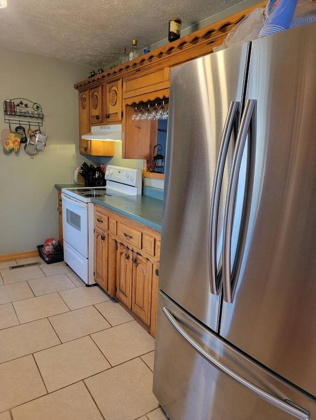 7 Lawrence Unit 2200, Wentworth, MO 64873 - kitchen with freestanding refrigerator, white electric range oven, dark countertops, a textured ceiling, and under cabinet range hood