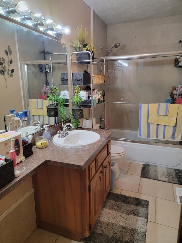 7 Lawrence Unit 2200, Wentworth, MO 64873 - bathroom featuring vanity, bath / shower combo with glass door, toilet, and tile patterned flooring