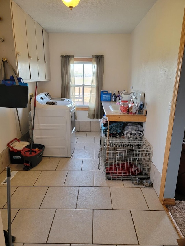 7 Lawrence Unit 2200, Wentworth, MO 64873 - laundry area with cabinet space, washing machine and dryer, and light tile patterned floors