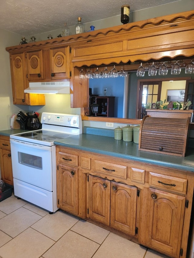 7 Lawrence Unit 2200, Wentworth, MO 64873 - kitchen featuring under cabinet range hood, white range with electric stovetop, brown cabinets, dark countertops, and a textured ceiling