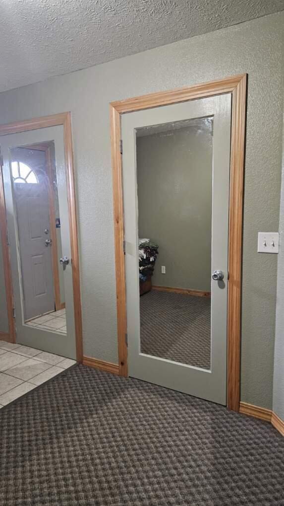 7 Lawrence Unit 2200, Wentworth, MO 64873 - hallway with carpet flooring, baseboards, a textured wall, and a textured ceiling