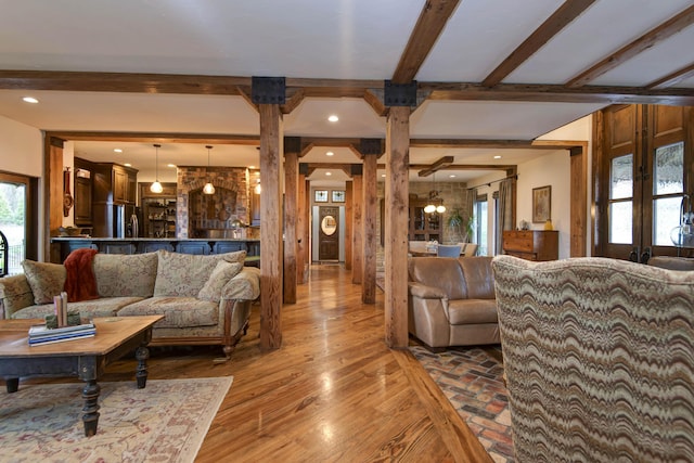 living area with decorative columns, beamed ceiling, wood finished floors, and recessed lighting