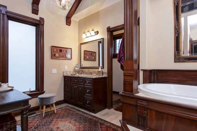 full bath with baseboards, a garden tub, tile patterned flooring, and vanity