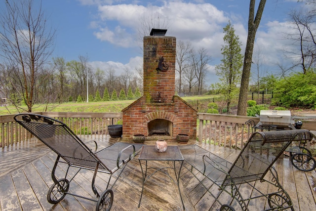 wooden deck featuring an outdoor brick fireplace