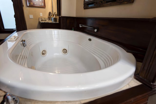 room details featuring vanity and a whirlpool tub