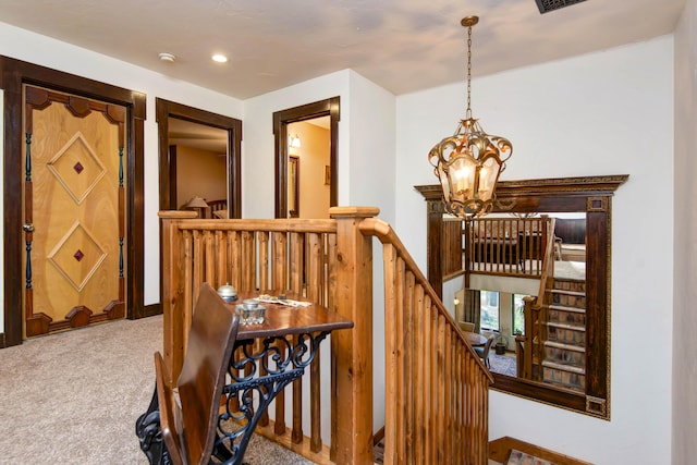 stairway featuring recessed lighting, carpet flooring, and an inviting chandelier