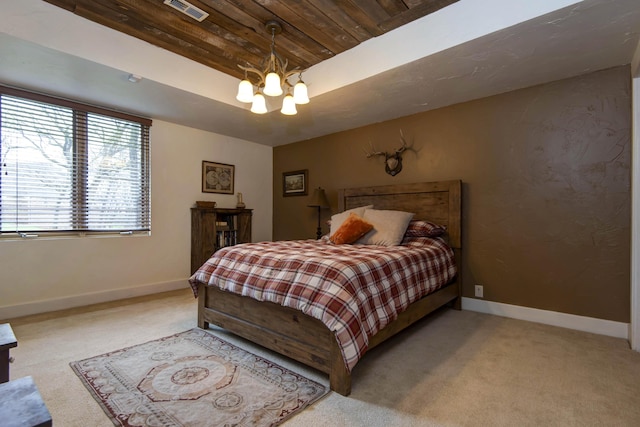 carpeted bedroom with a tray ceiling, baseboards, wood ceiling, and an inviting chandelier