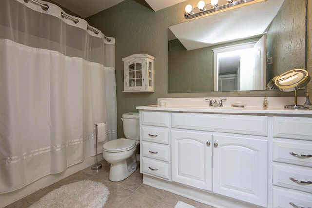 full bath with tile patterned flooring, vanity, shower / tub combo, toilet, and a textured wall
