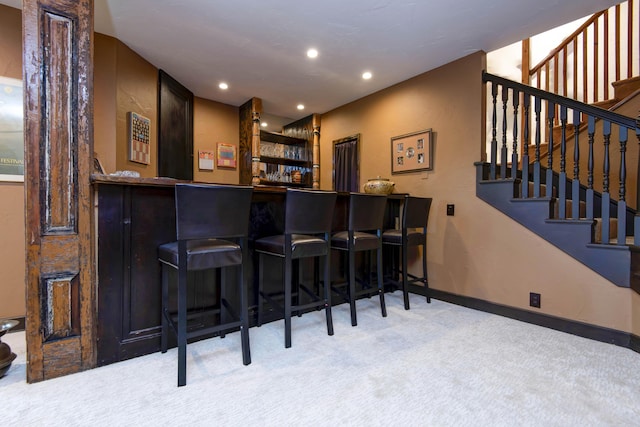 bar with stairway, recessed lighting, baseboards, carpet floors, and a bar
