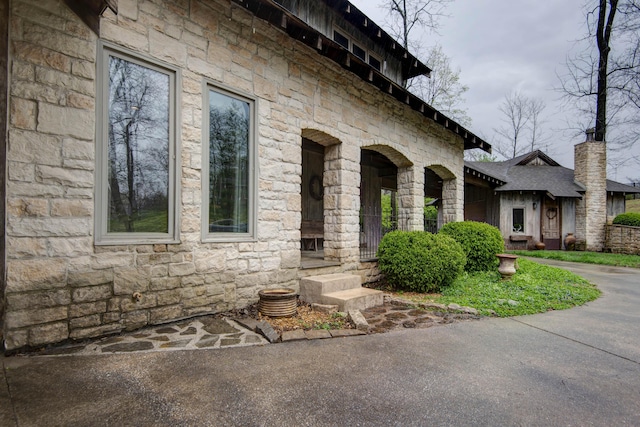 exterior space featuring stone siding