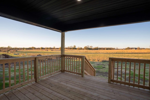 wooden deck with a rural view