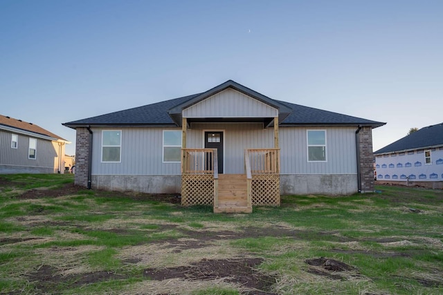 back of house with a shingled roof