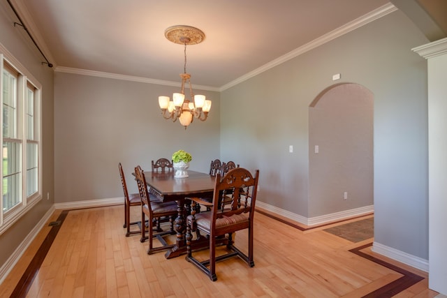 1321 E River Oak Dr, Springfield, MO 65803 - dining space with crown molding, baseboards, arched walkways, light wood-style floors, and a notable chandelier