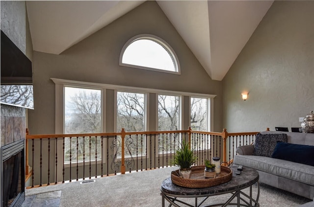 1321 E River Oak Dr, Springfield, MO 65803 - carpeted living room with a fireplace, high vaulted ceiling, visible vents, and a textured wall