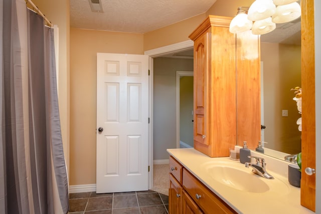 1321 E River Oak Dr, Springfield, MO 65803 - bathroom featuring a textured ceiling, visible vents, baseboards, vanity, and tile patterned flooring
