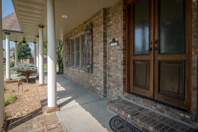 1321 E River Oak Dr, Springfield, MO 65803 - view of exterior entry featuring covered porch, brick siding, and roof with shingles