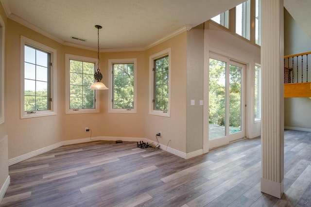 1321 E River Oak Dr, Springfield, MO 65803 - unfurnished dining area with a wealth of natural light, crown molding, and wood finished floors