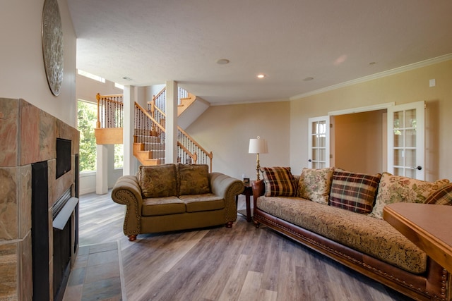 1321 E River Oak Dr, Springfield, MO 65803 - living area with a fireplace, crown molding, wood finished floors, and stairway
