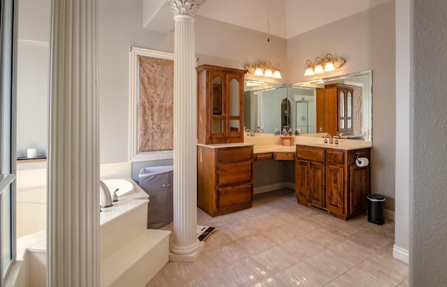 1321 E River Oak Dr, Springfield, MO 65803 - bathroom with baseboards, a garden tub, vanity, and ornate columns