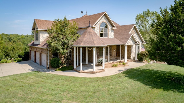 1321 E River Oak Dr, Springfield, MO 65803 - view of front of house with stone siding, concrete driveway, a front lawn, a shingled roof, and a porch