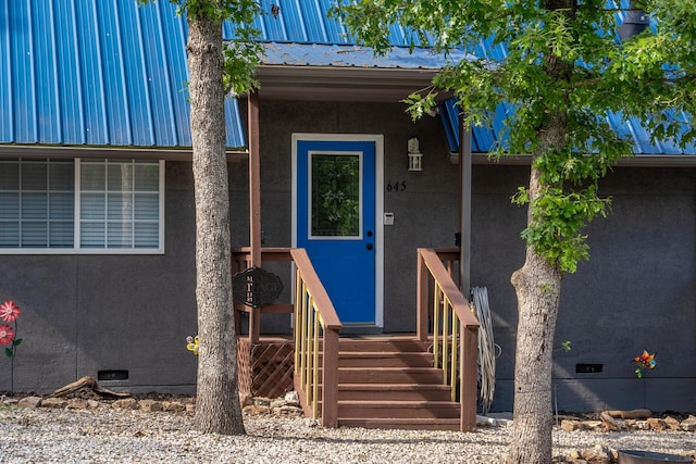 645 Buck Run Dr, Branson West, MO 65737 - view of exterior entry featuring crawl space, metal roof, and stucco siding