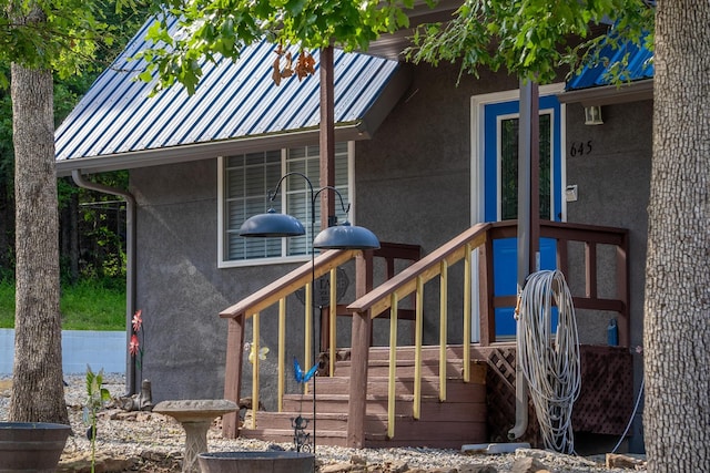 645 Buck Run Dr, Branson West, MO 65737 - doorway to property featuring stucco siding and metal roof