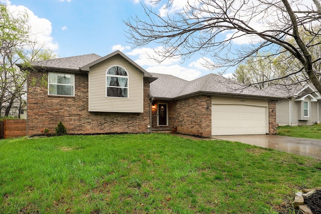 split level home featuring a shingled roof, an attached garage, brick siding, a front lawn, and driveway
