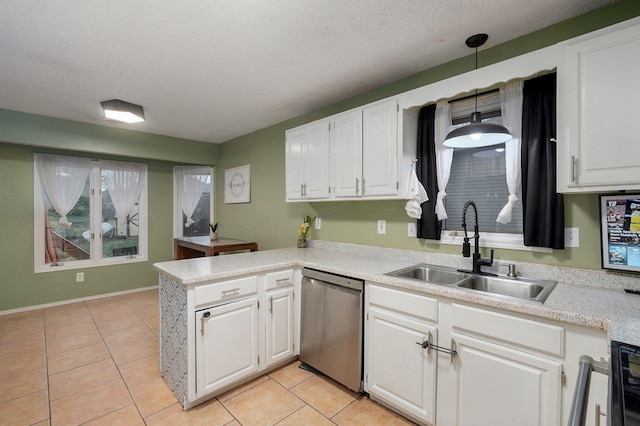 kitchen featuring a peninsula, white cabinetry, dishwasher, light countertops, and a sink
