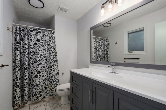 bathroom with visible vents, toilet, marble finish floor, and a textured ceiling