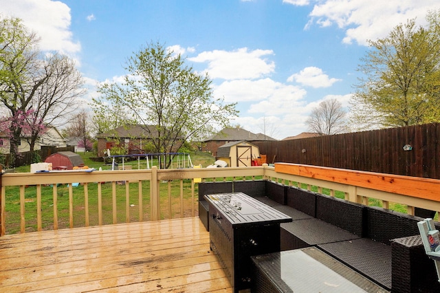 wooden deck with a trampoline, a lawn, an outdoor structure, an outdoor hangout area, and a storage unit