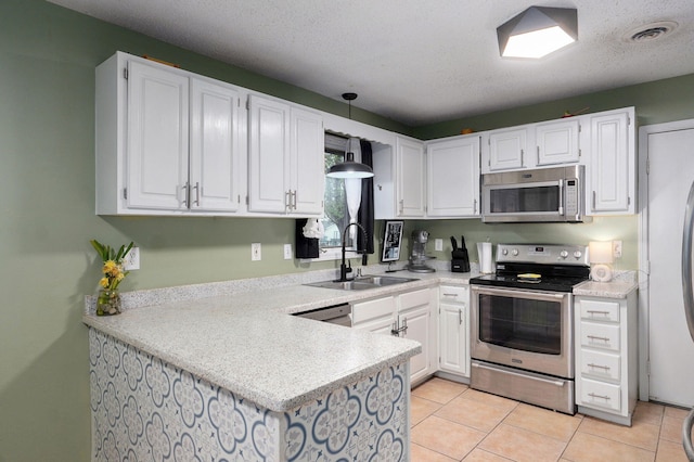 kitchen featuring white cabinets, visible vents, a sink, and appliances with stainless steel finishes