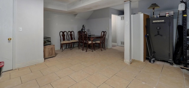 dining space featuring light tile patterned flooring, baseboards, and visible vents