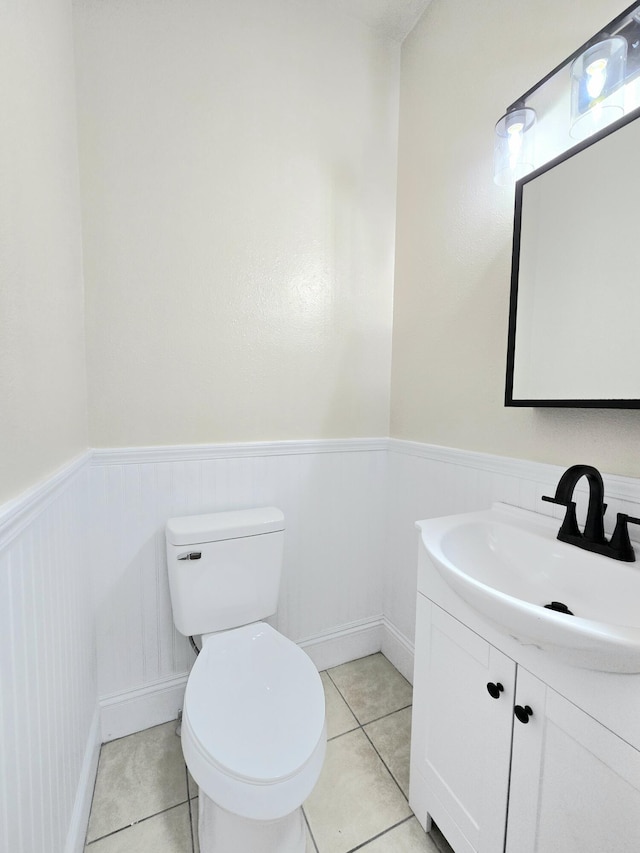 1511 W Lee St, Springfield, MO 65803 - bathroom with toilet, tile patterned floors, vanity, and wainscoting