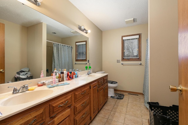 3740 W Glenwood Ct, Springfield, MO 65807 - bathroom with toilet, double vanity, a sink, and tile patterned flooring