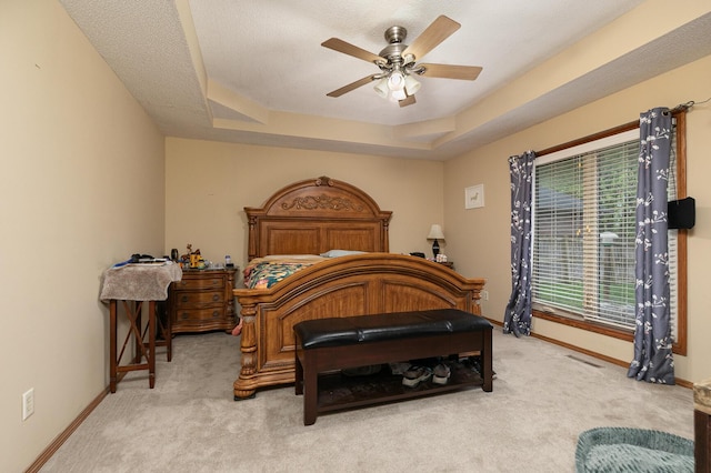 3740 W Glenwood Ct, Springfield, MO 65807 - carpeted bedroom featuring a tray ceiling, baseboards, and ceiling fan