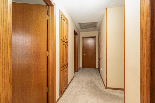 3740 W Glenwood Ct, Springfield, MO 65807 - hall with visible vents, baseboards, light colored carpet, and a textured ceiling