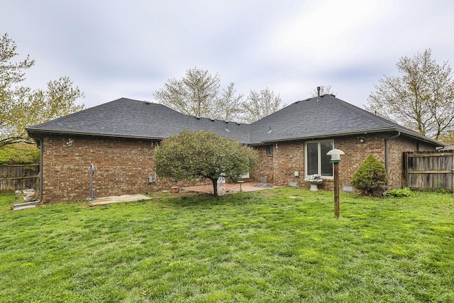 3740 W Glenwood Ct, Springfield, MO 65807 - rear view of property featuring a patio area, brick siding, fence, and a lawn