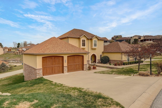 view of front of property with a garage, stucco siding, stone siding, a front lawn, and driveway