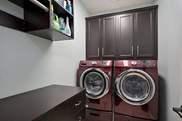 laundry room featuring cabinet space, tile patterned floors, and separate washer and dryer